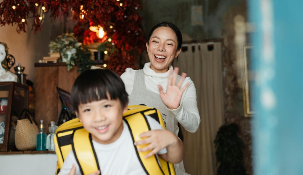 A Japanese mother waving goodbye to her son.