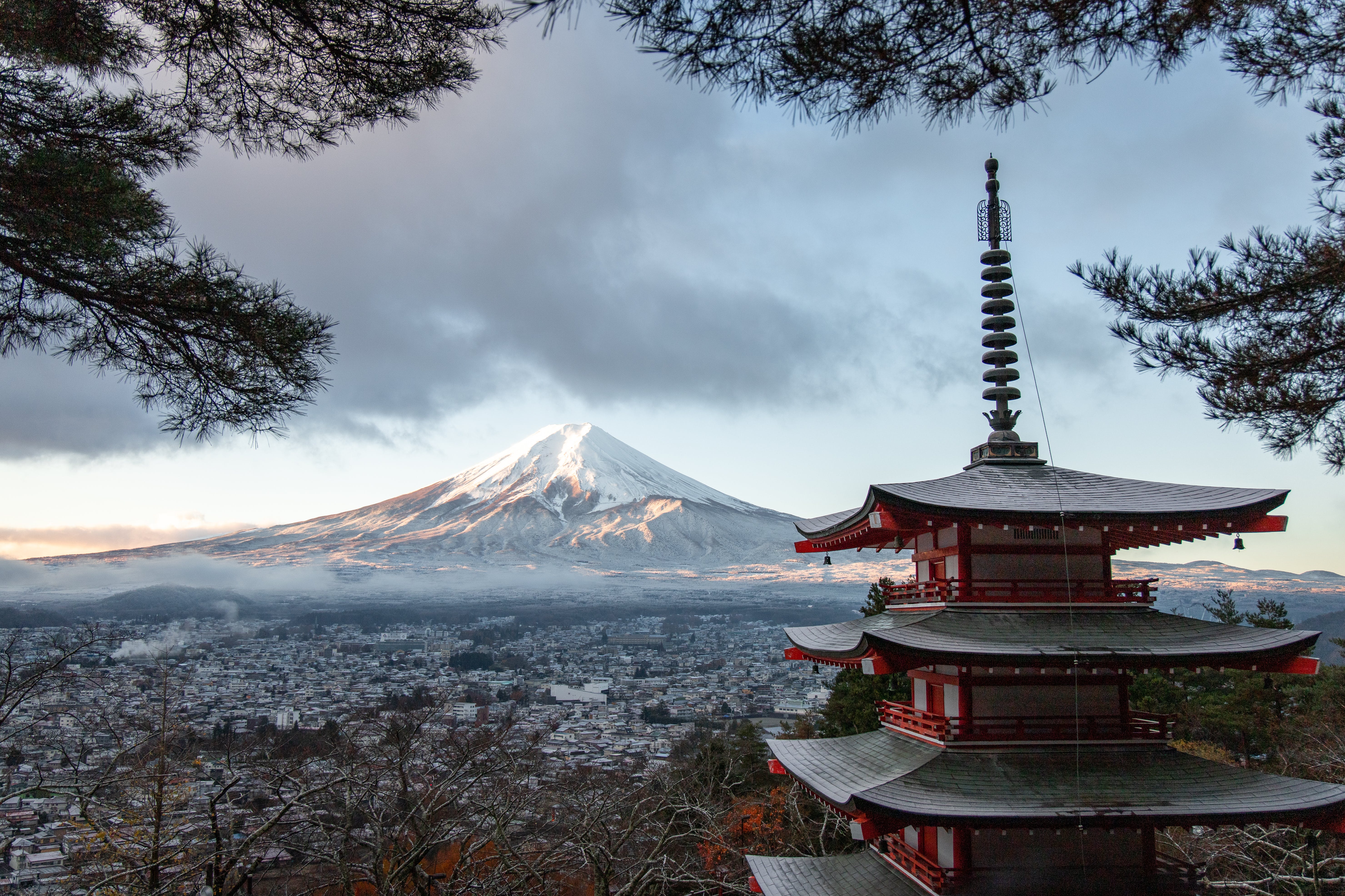 Mount Fuji looming behind a Buddhist temple in Japan