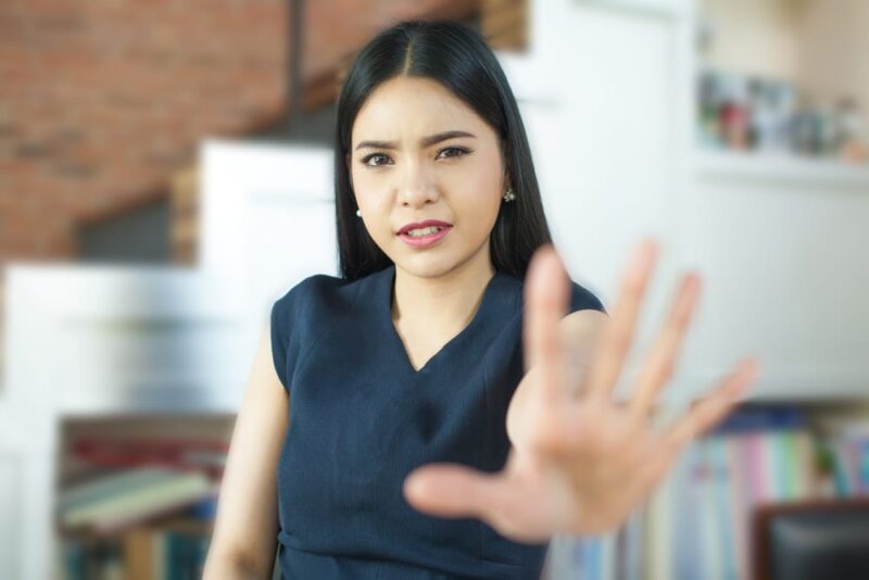woman-signaling-no-stop-with-her-hand-up