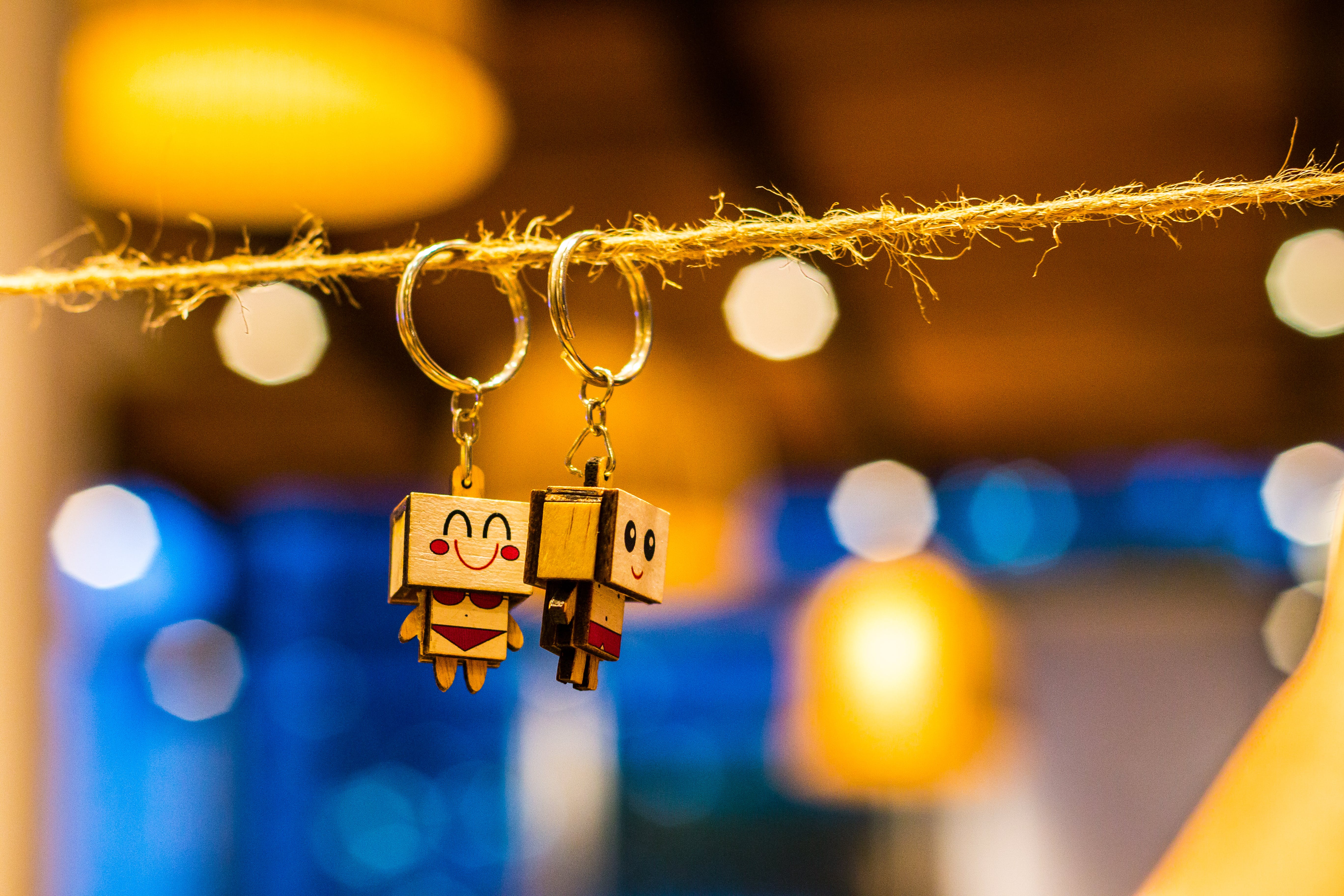 A matching pair of keychains hangs on a line
