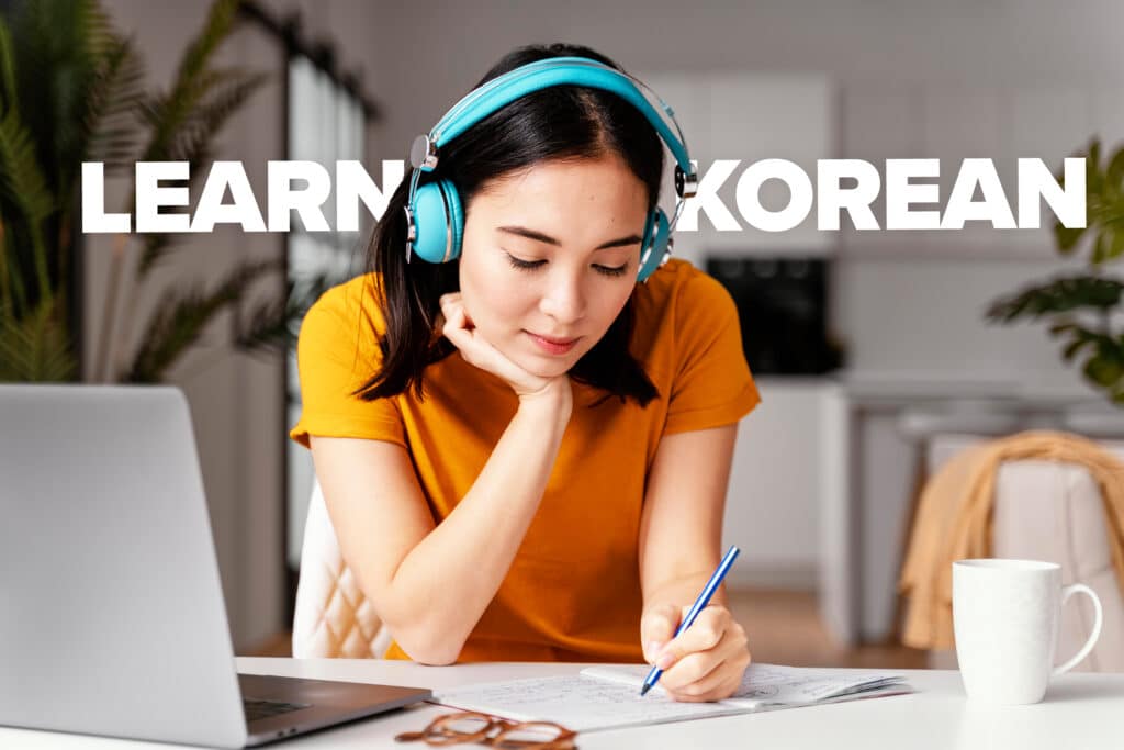 Girl in orange t-shirt and headphones in front of text reading 'Learn Korean'
