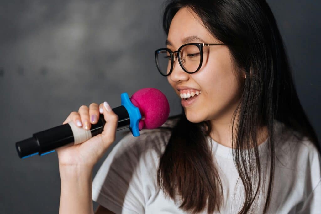 young-woman-in-glasses-singing-karaoke