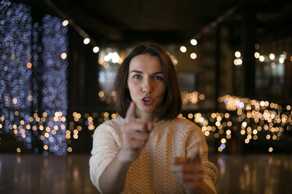 an image of a woman pointing when speaking
