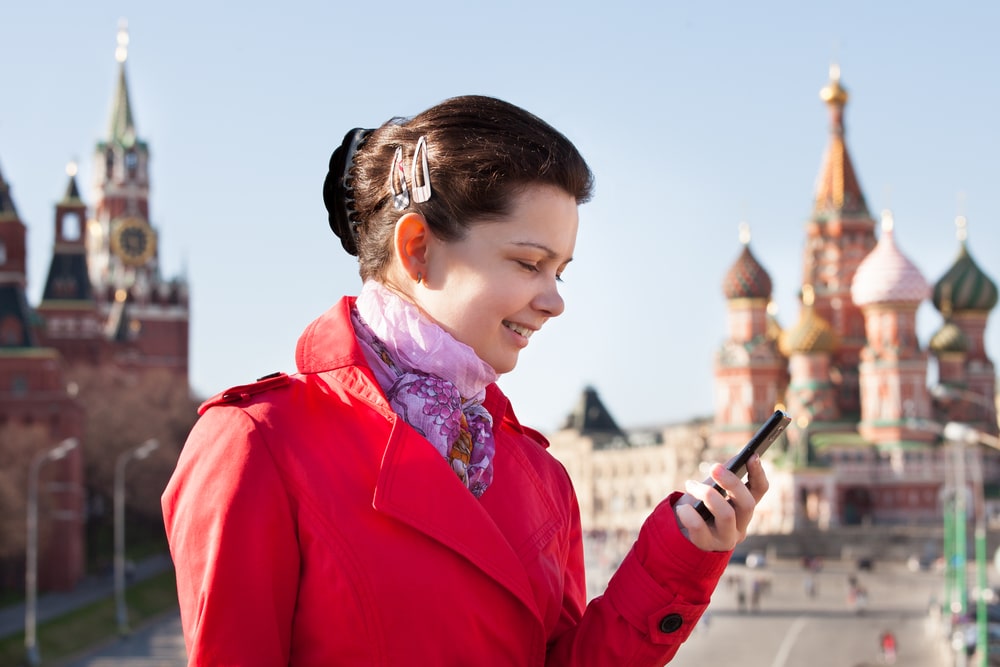 Woman-outside-in-Russian-town-holding-phone