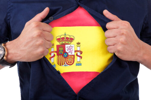 A man revealing a Spanish flag on his chest