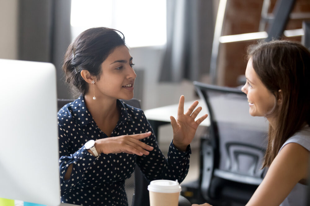 picture-of-two-women-talking-in-an-office