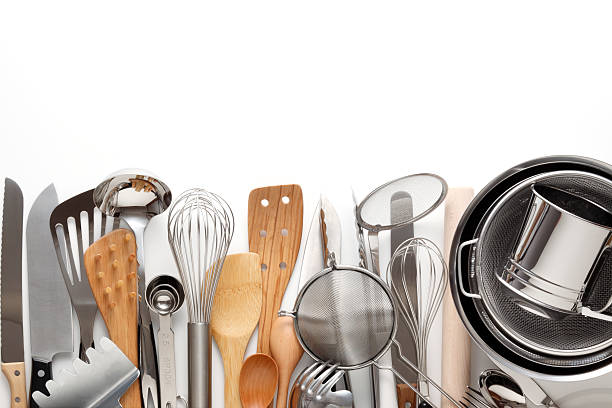 Cooking utensils in a row on a white background