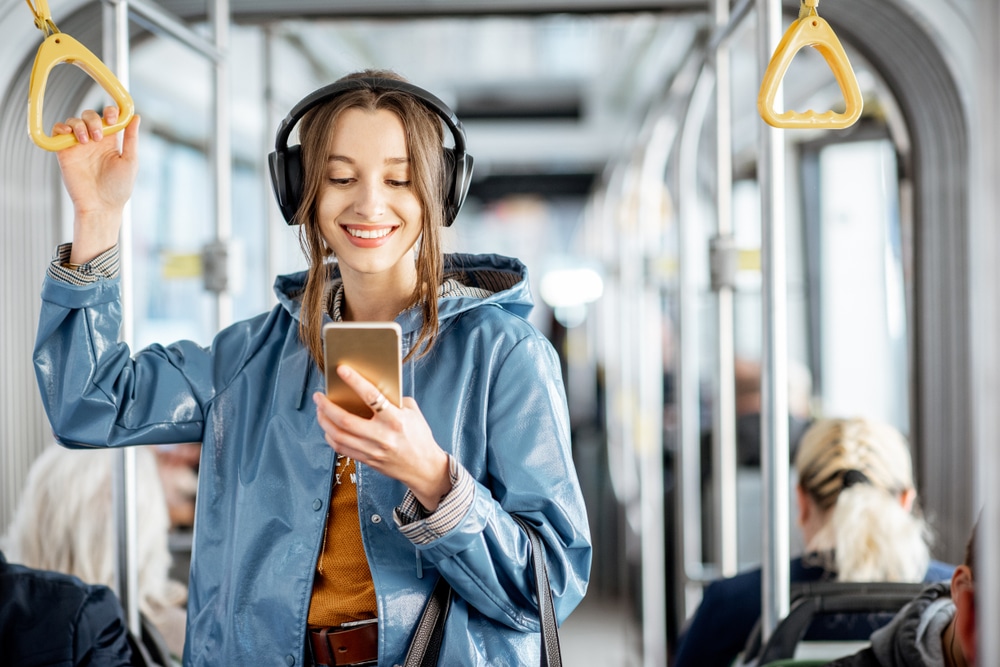 young-woman-using-phone-on-bus