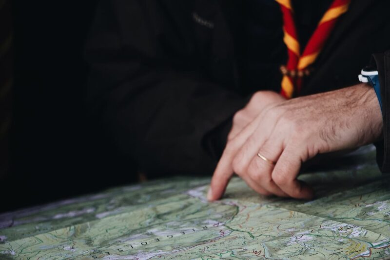 Close-up of a man's hand pointing on a map
