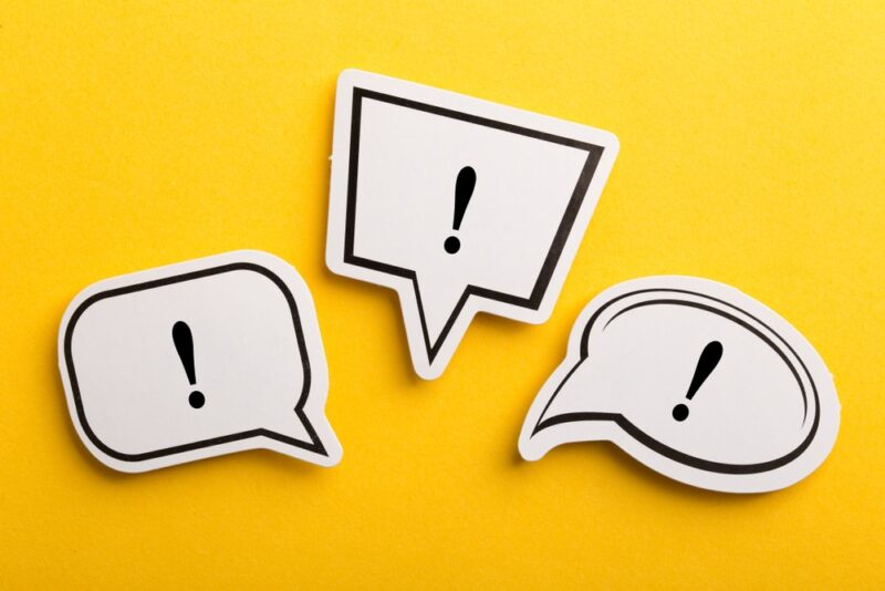 exclamation marks in speech bubbles on yellow background