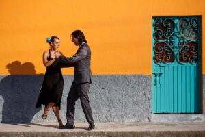 man and woman dancing tango on the street