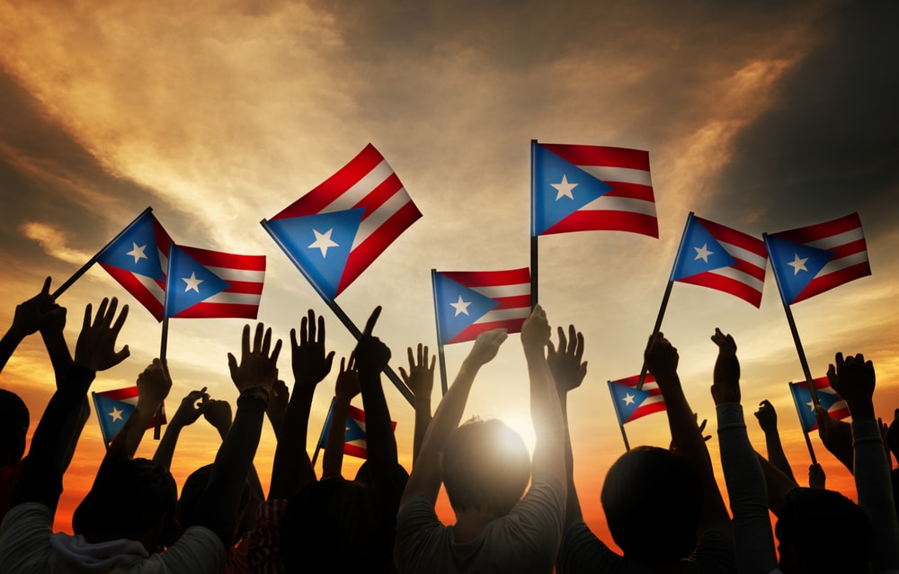 people waving puerto rican flags in the sky