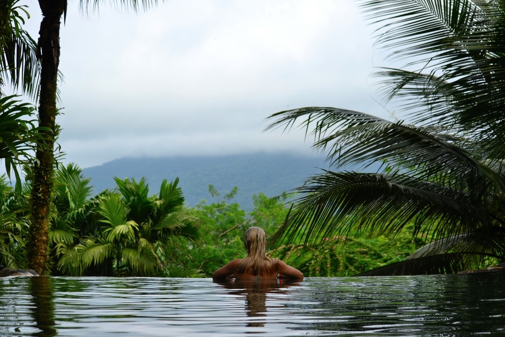 woman swimming in infinity pool in costa rica