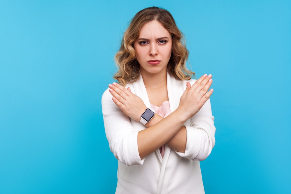 woman-signaling-no-with-crossed-arms
