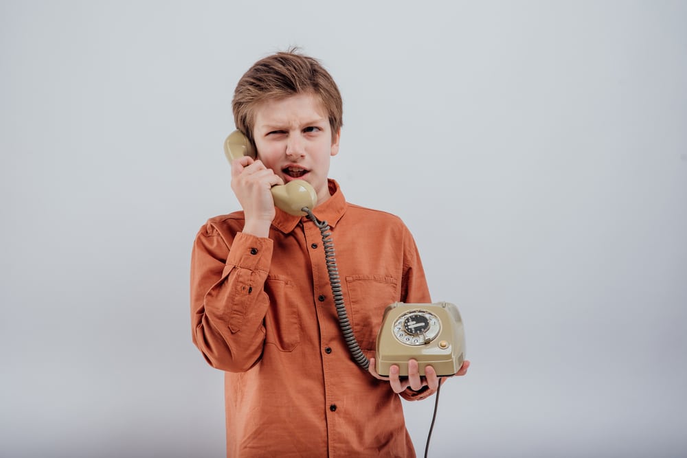 preteen-talking-on-old-rotary-phone