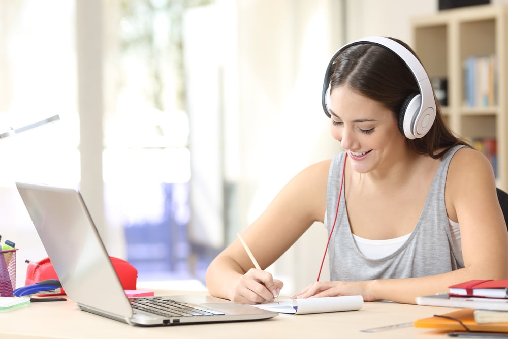 young-woman-studying-with-laptop-and-headphones