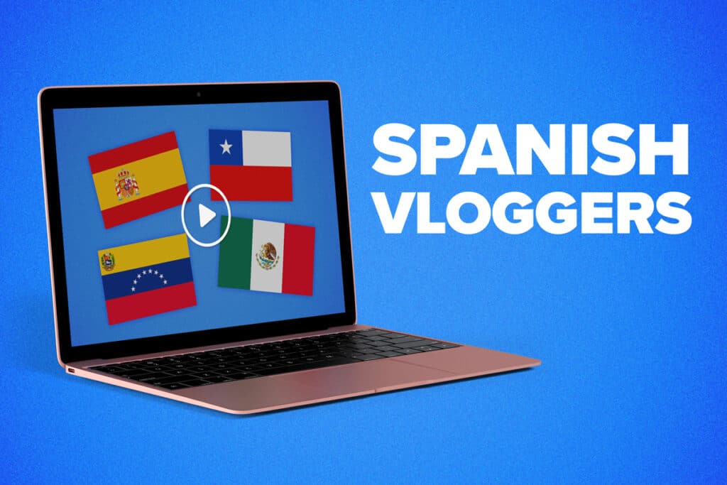 a-laptop-with-the-flags-of-spain-chile-venezuela-and-mexico-and-a-play-button-with-the-words-spanish-vloggers