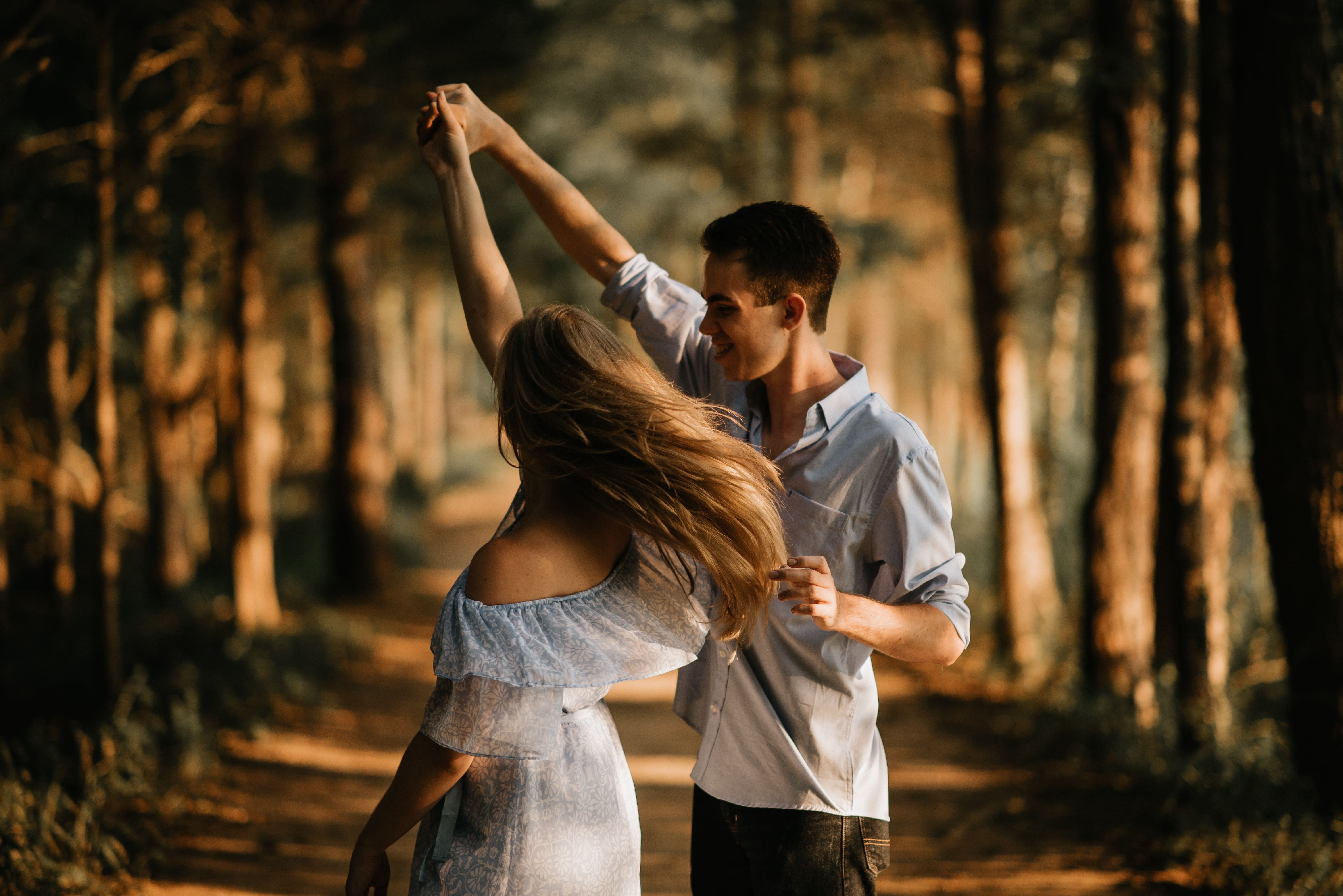 A couple dances in the forest