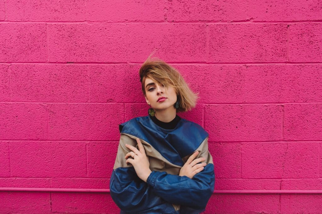 young woman against a pink background