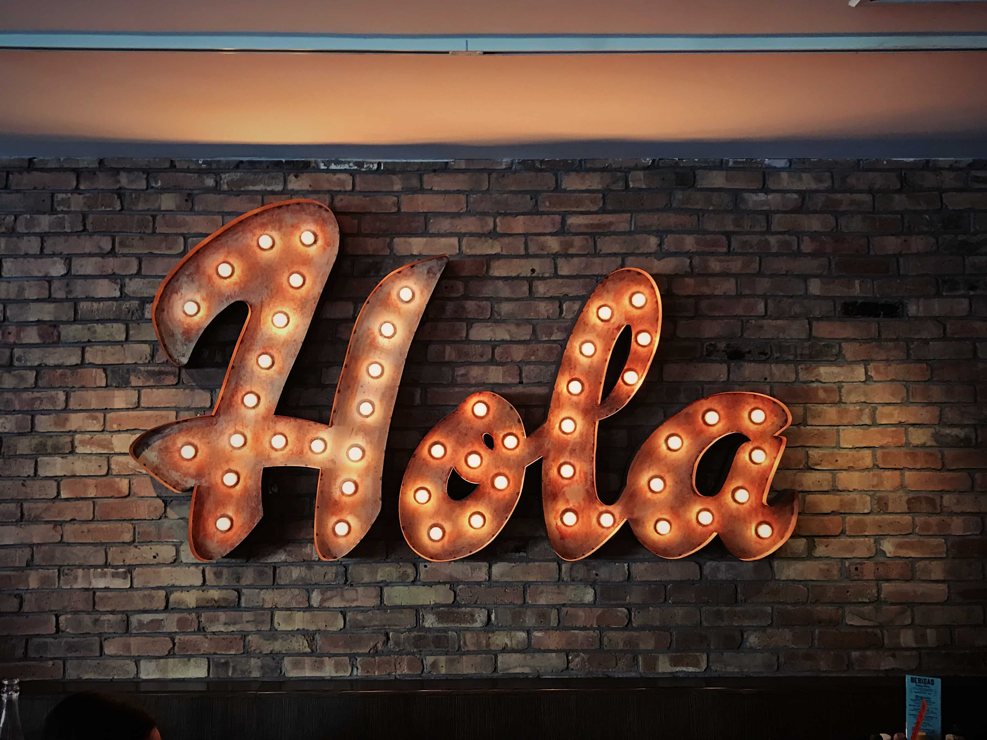 An "Hola" sign with lights