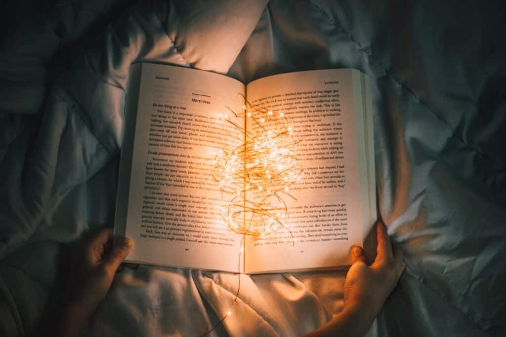 An open book filled with tiny lights
