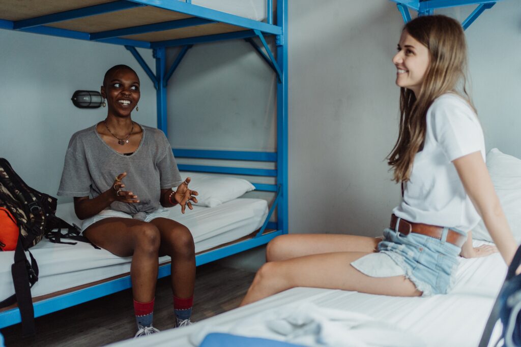 two-women-chatting-in-hostel-dorm
