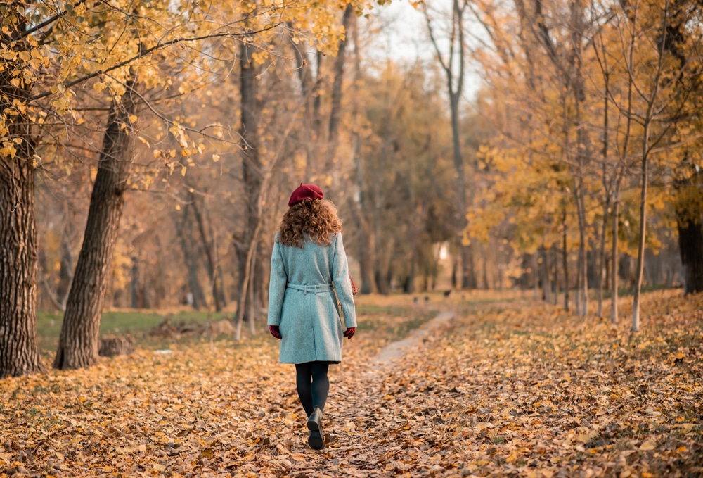 woman-walking-in-woods-during-fall