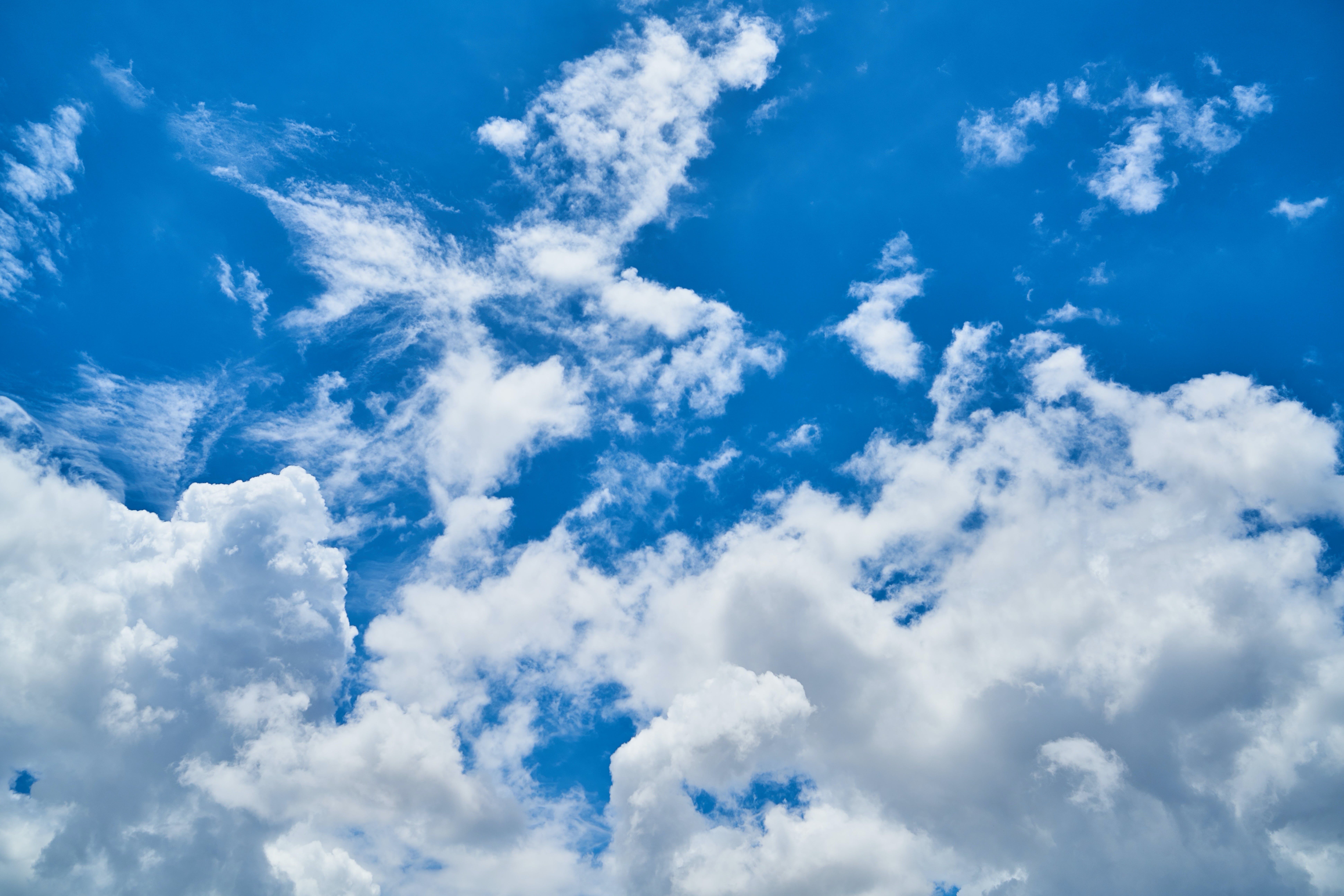 A blue sky with puffy white clouds