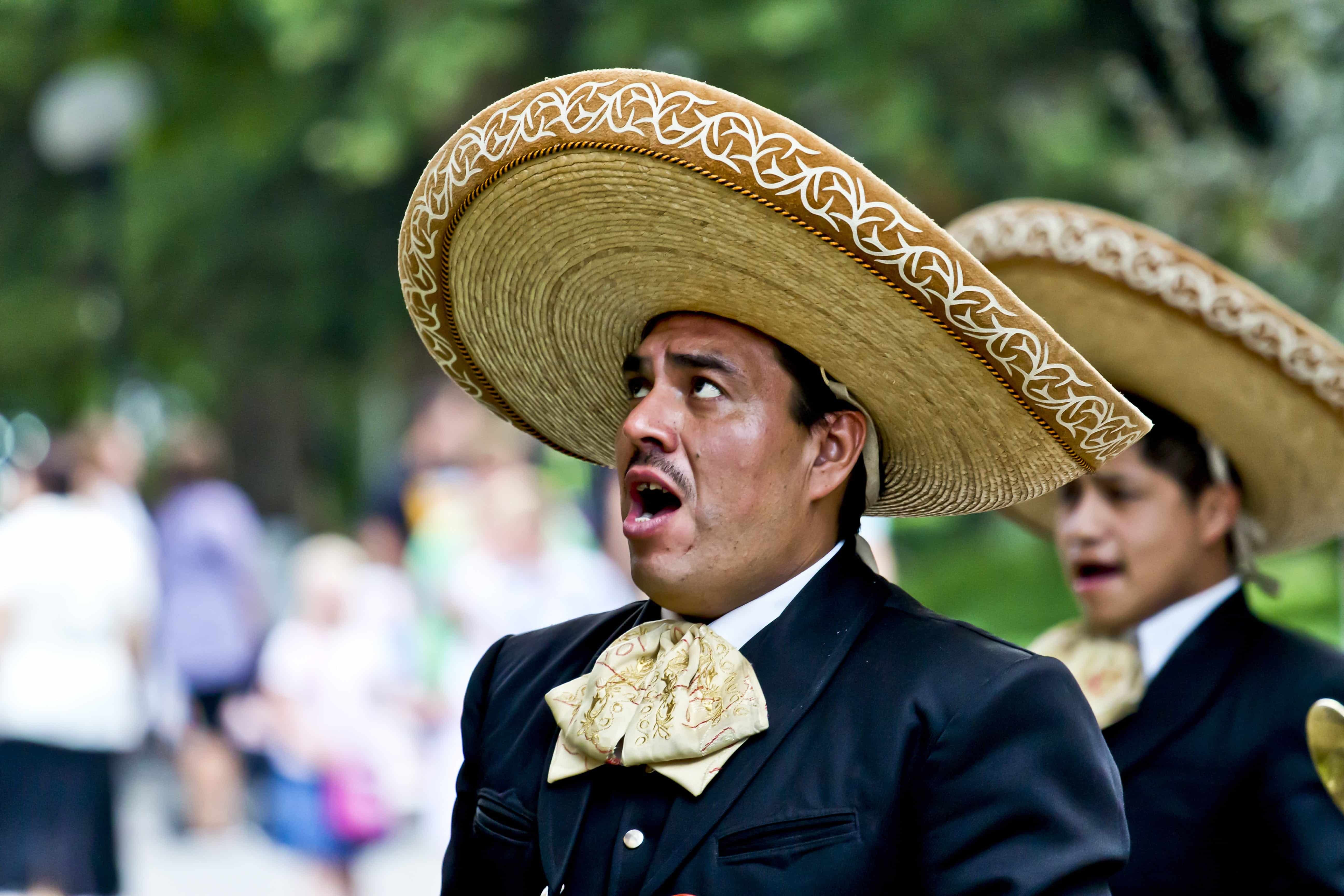 A Mexican man wearing a sombrero sings