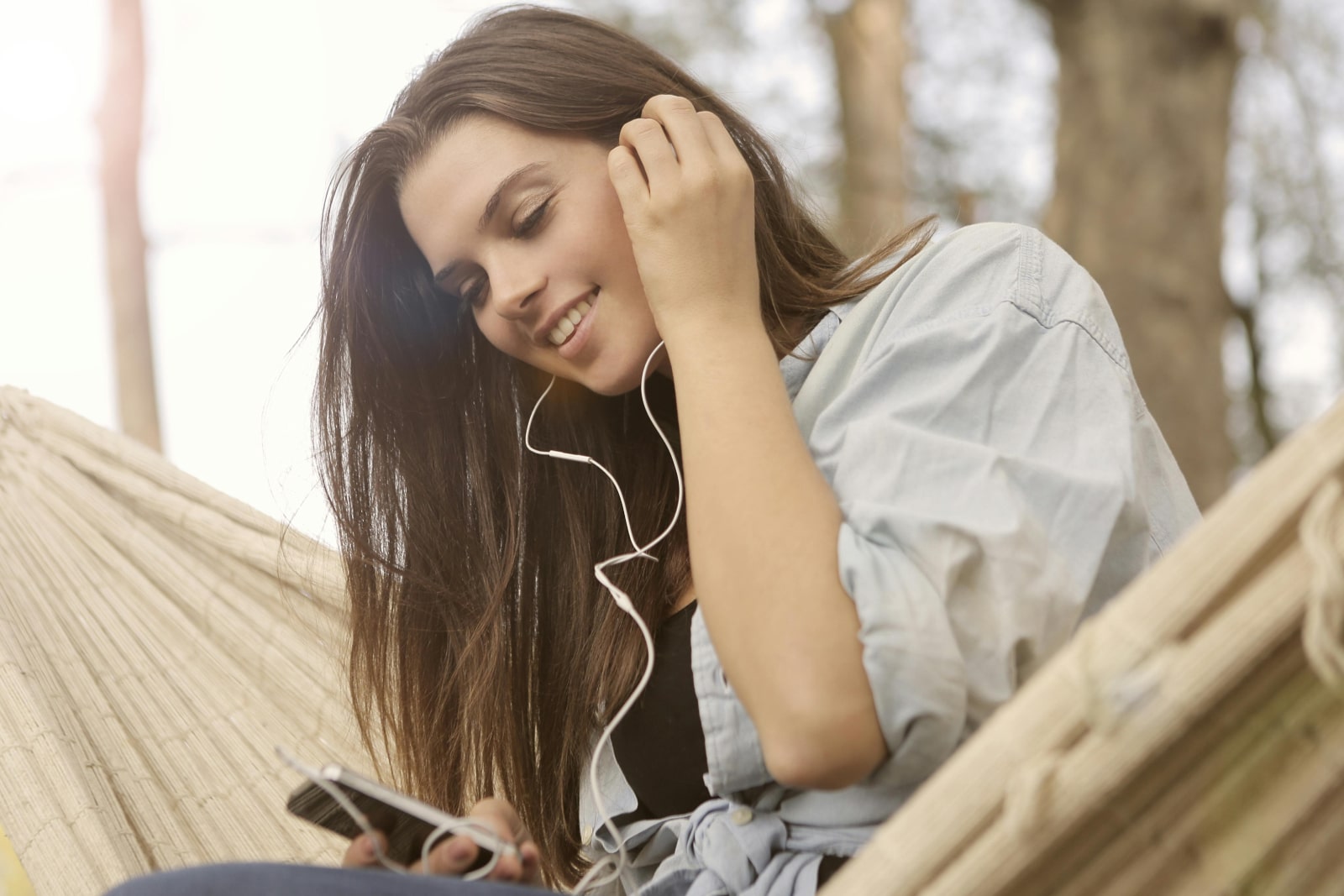 Girl listening to music through earphones