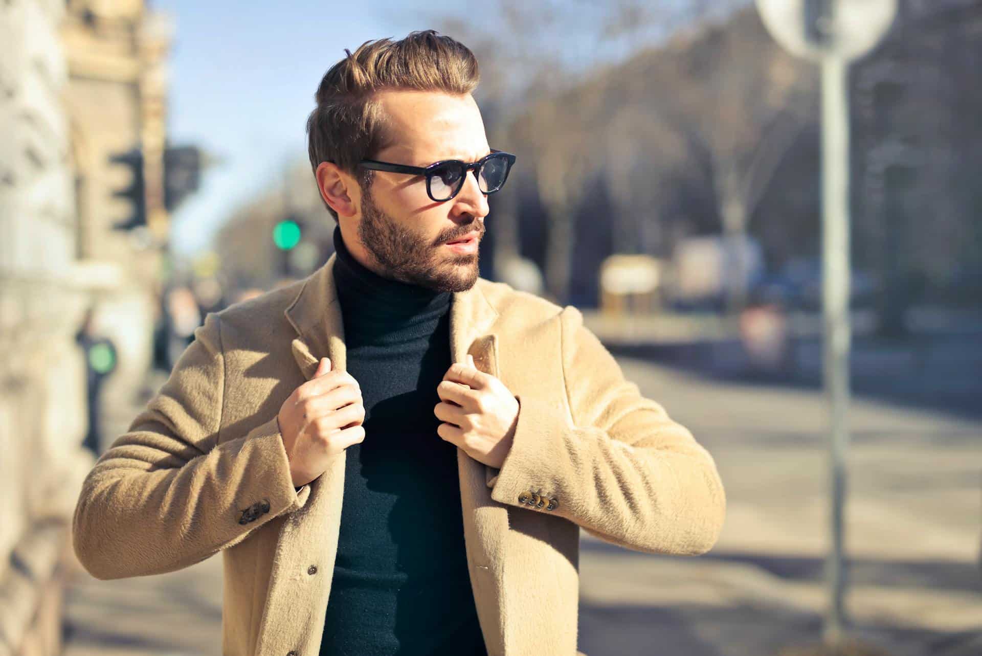 handsome-man-wearing-glasses-and-brown-jacket-walking-down-the-street