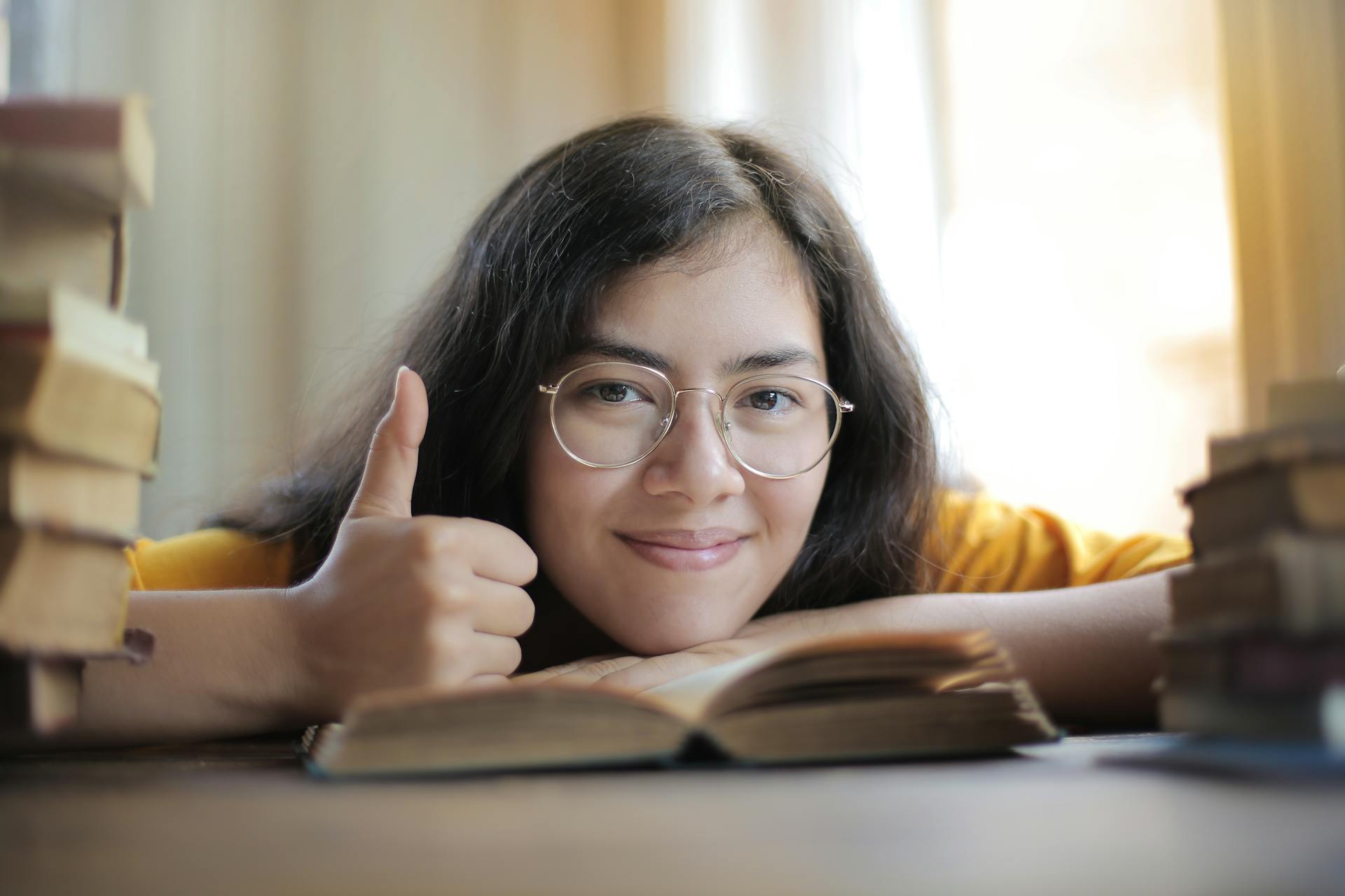 woman-in-glasses-in-focus-holding-her-thumb-up