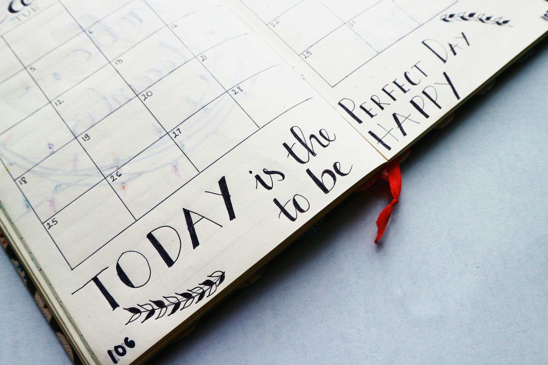 close-up-of-planner-with-calligraphy-of-words-today-is-the-perfect-day-to-be-happy