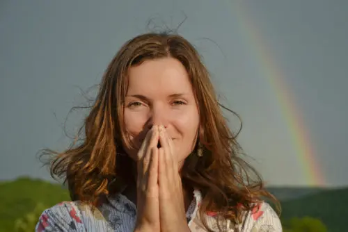 Grateful woman with hands pressed together, saying thank you