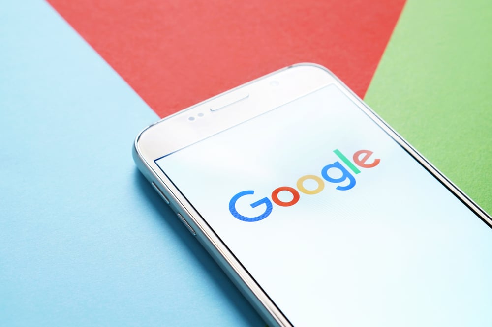 Phone with Google on it in front of colorful background