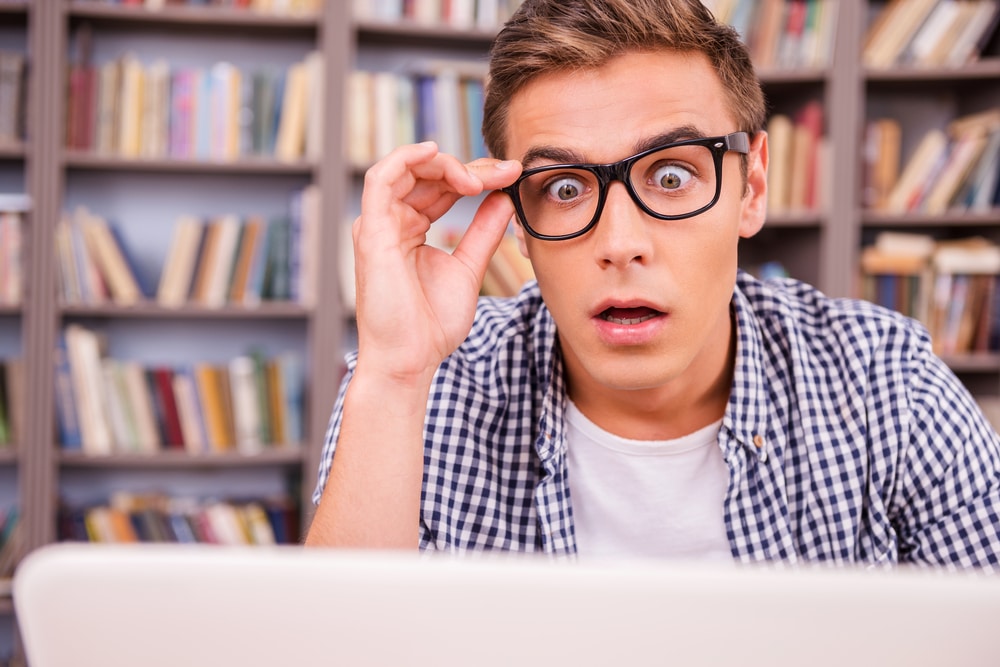 Man in glasses looking at laptop