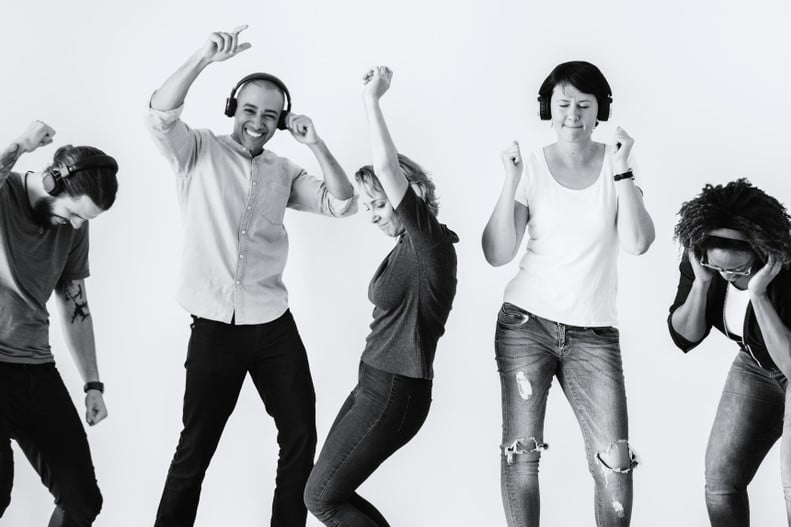 black and white photo of people dancing, smiling with headphones on