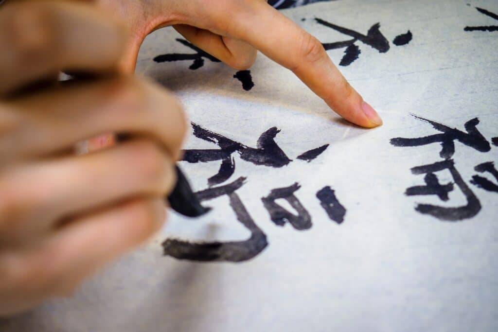 close-up-of-person-writing-chinese-character-calligraphy