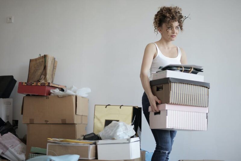woman-moving-boxes-from-a-bigger-pile-of-boxes
