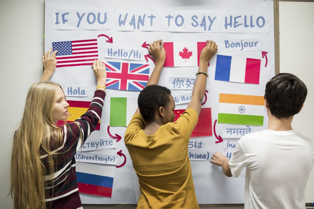 students putting up flags to represent different languages