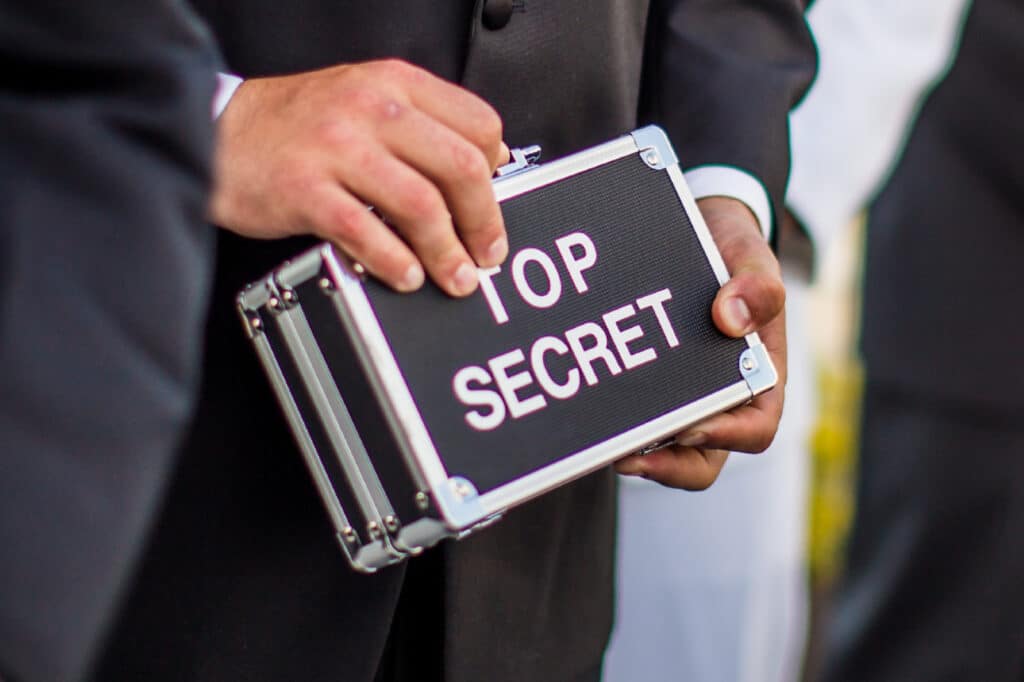 Person holding a top secret box