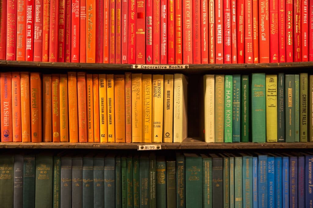 Color coordinated books on a shelf