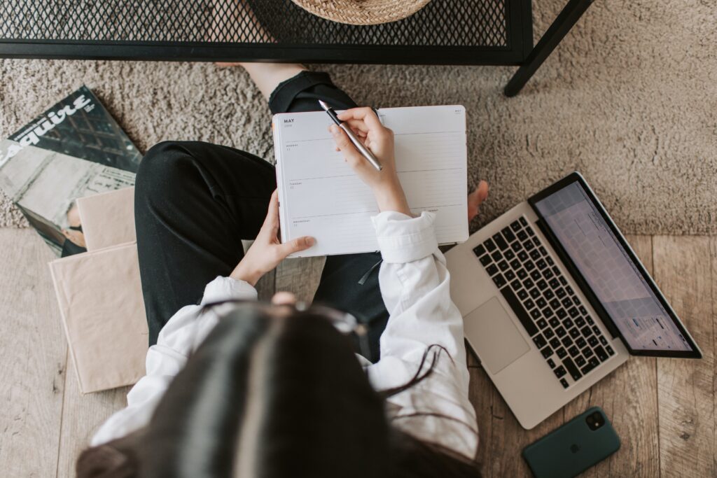 Photo by Vlada Karpovich: https://www.pexels.com/photo/faceless-lady-with-notebook-and-laptop-on-floor-at-home-4050302/