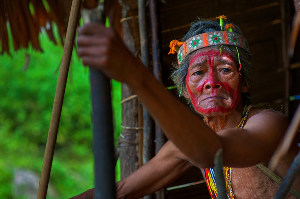 A tribe person with red face paint